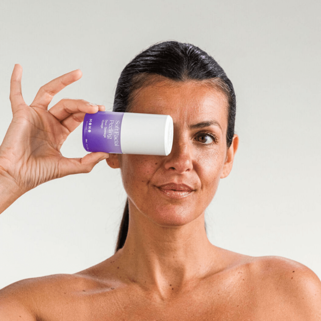 Femme tenant le gommage doux visage MONO – soin exfoliant naturel qui purifie et illumine la peau
