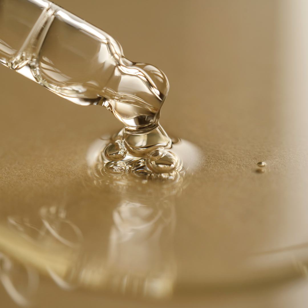 A bottle of retinol serum alongside a moisturizer on a bathroom counter.